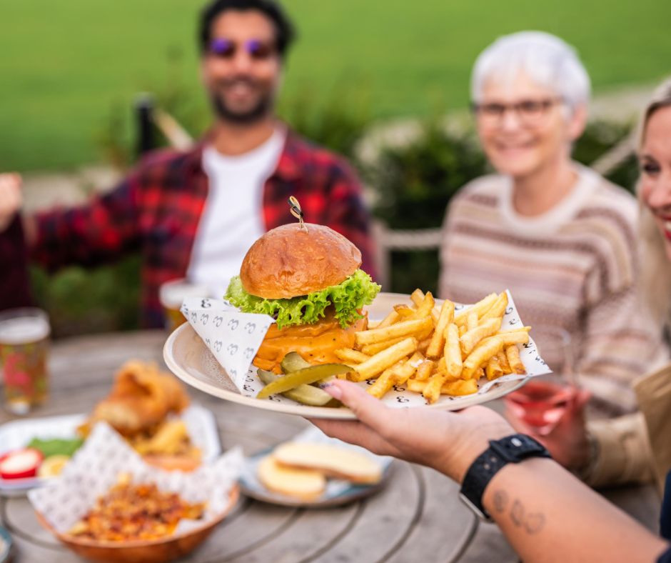 Serving a burger to a table of customers