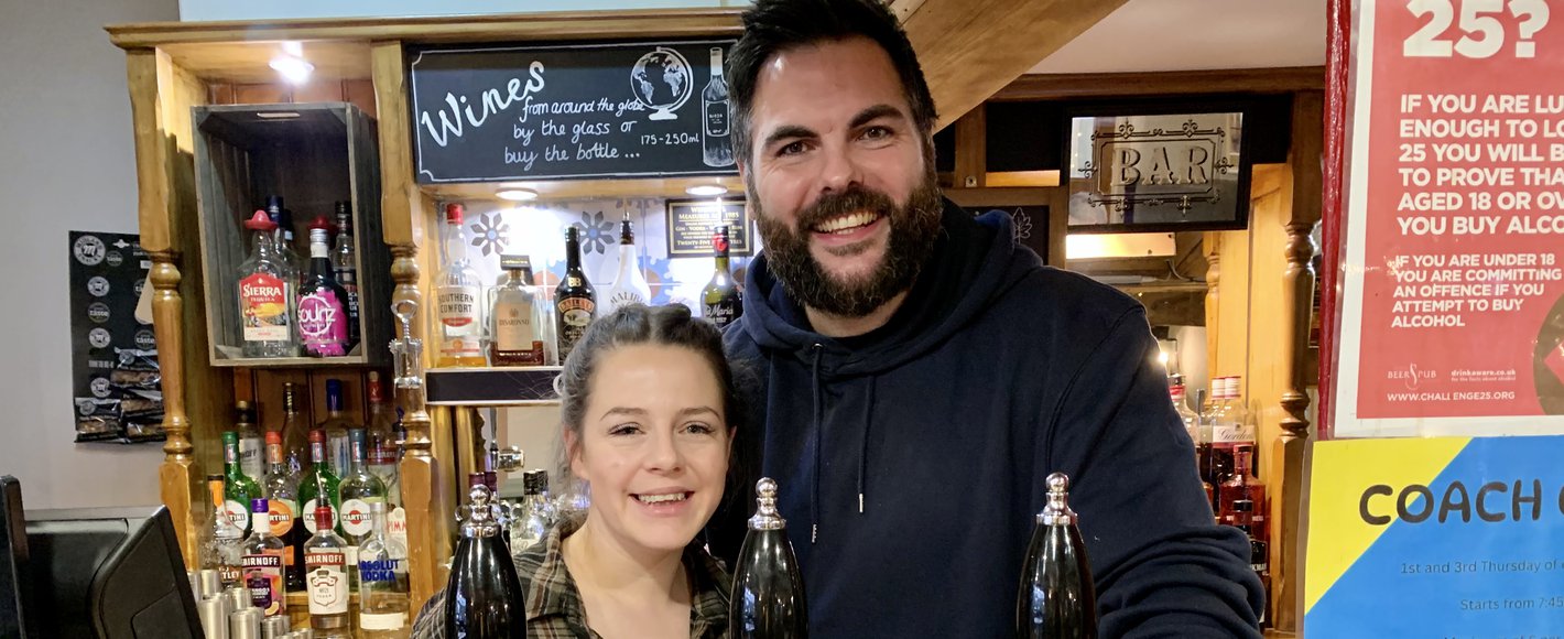 business owners at the coach and horses in markfield behind the bar