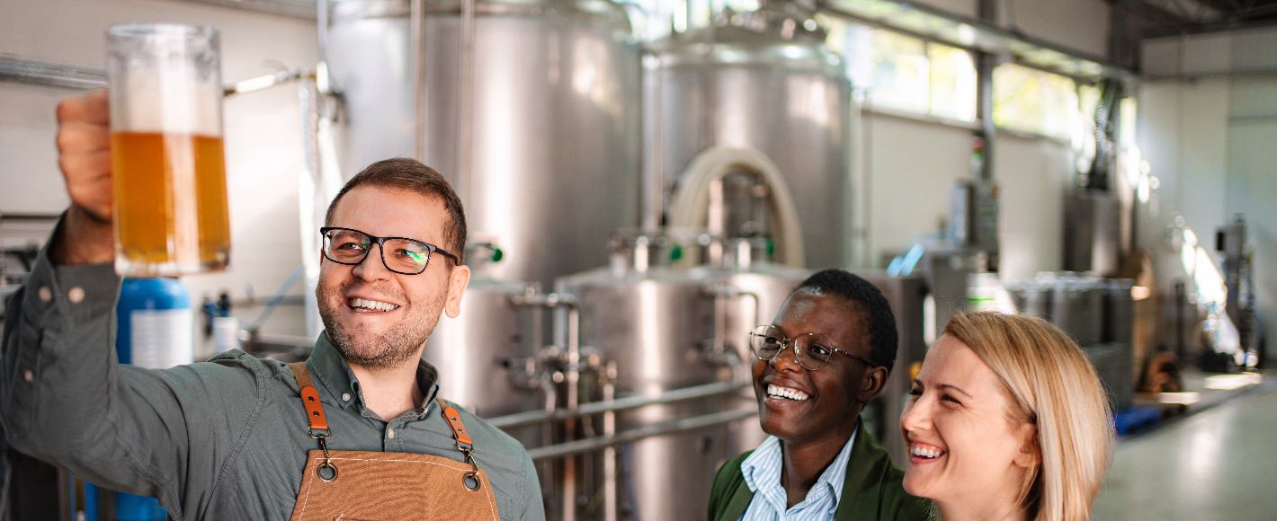 inside a brewery people looking at beer