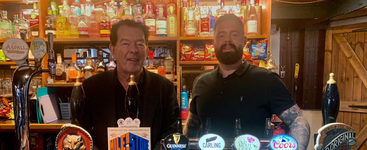 business owners behind the bar at the Plough in Littlethorpe
