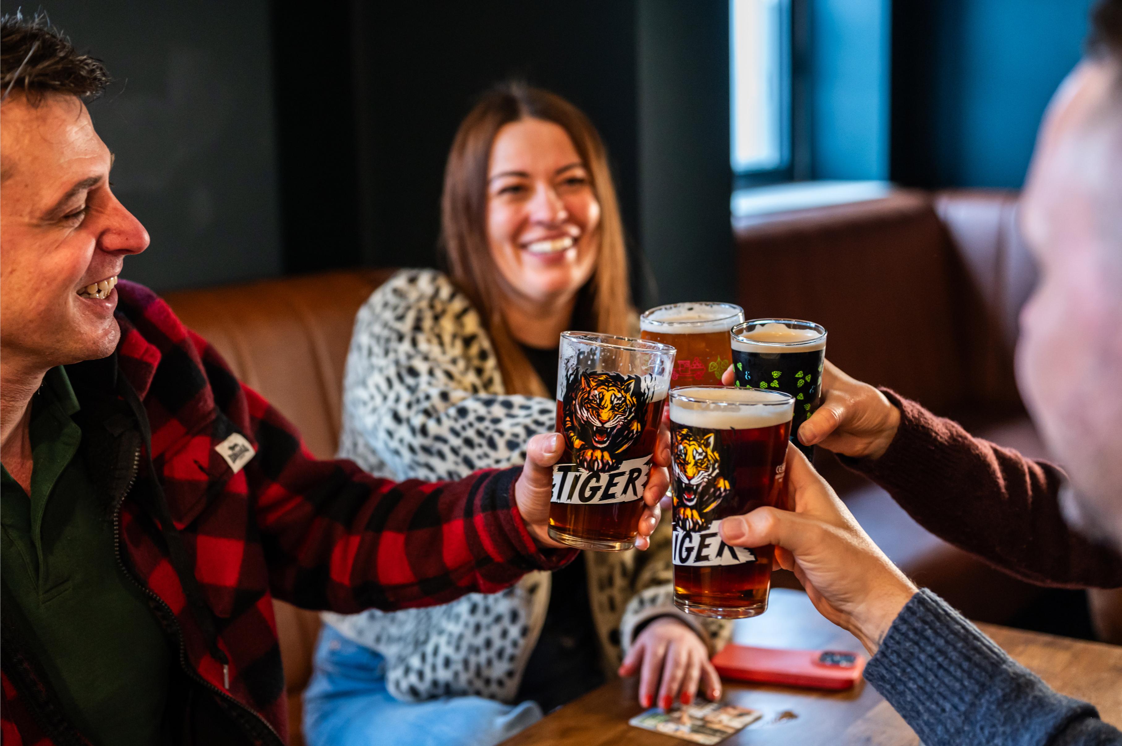 Group of people enjoying a beer down the pub