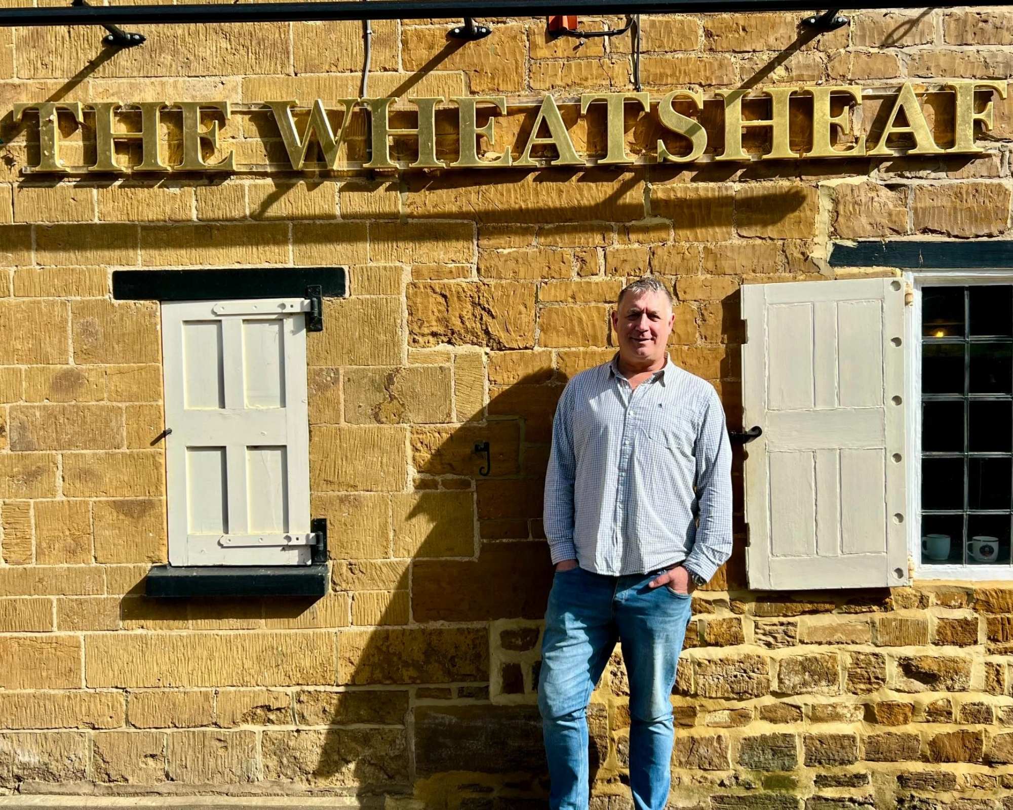 Lee at The Wheatsheaf in Dallington standing outside the pub
